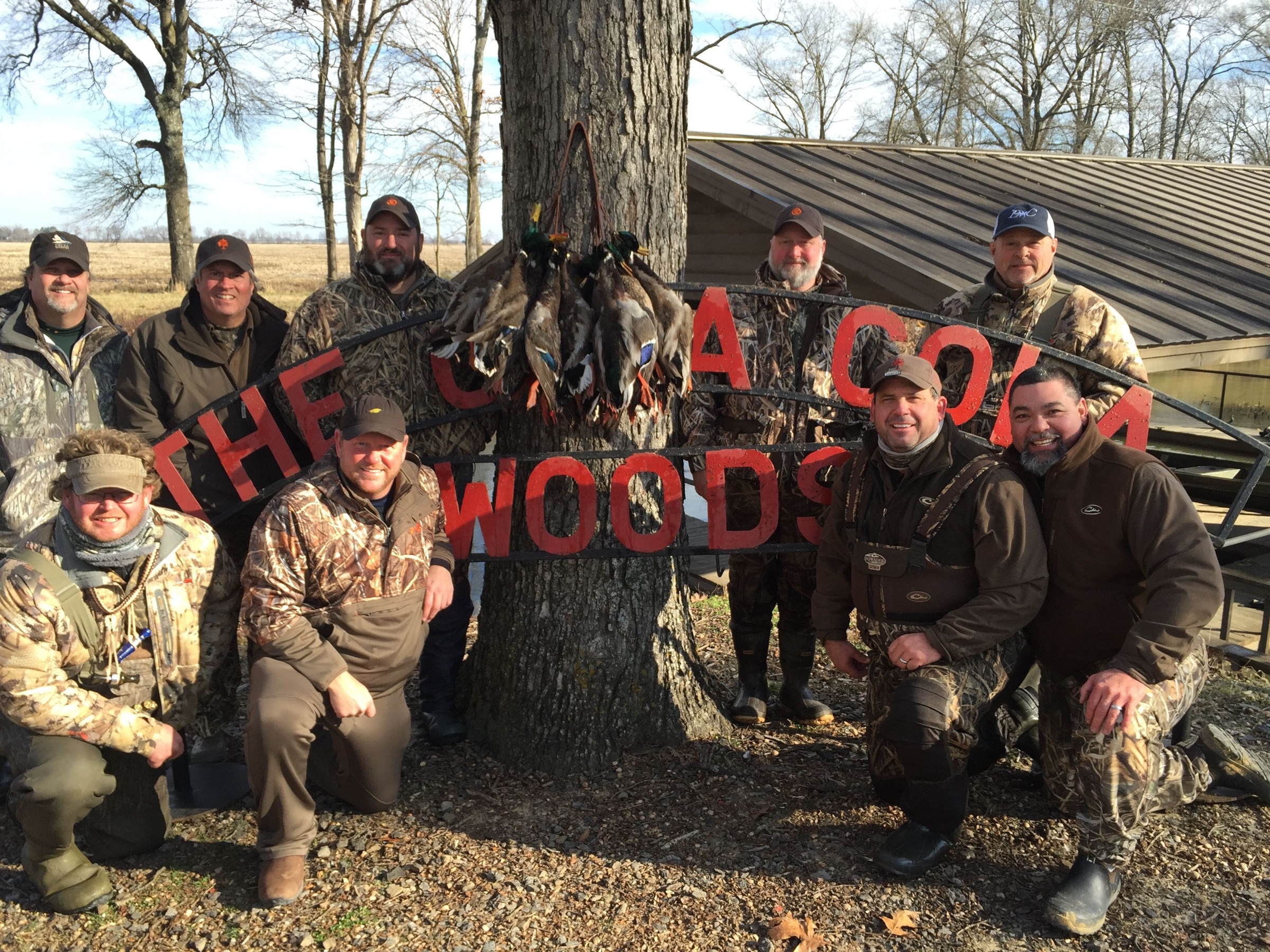 The winning party under the Coca-Cola Woods sign with the morning’s birds.